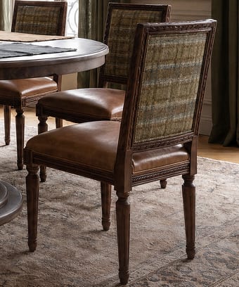 Woven dining chairs surrounding a round table